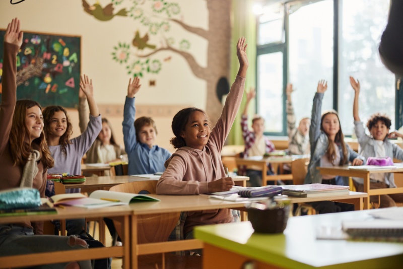 students raising hands